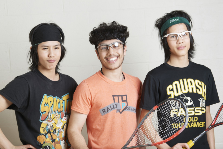 Portland Community Squash three young men with squash rackets